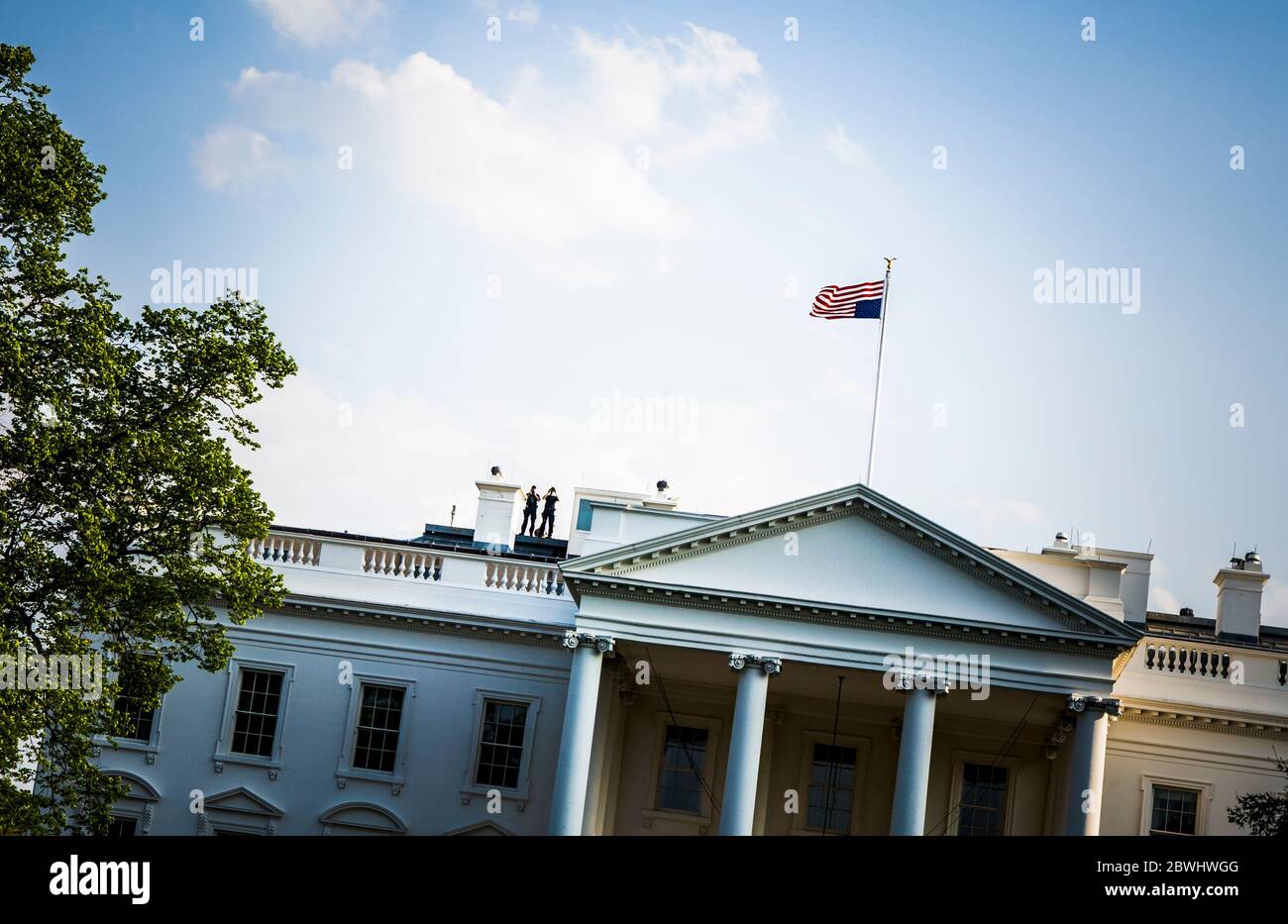 The White House with two security men on the roof with binoculars and