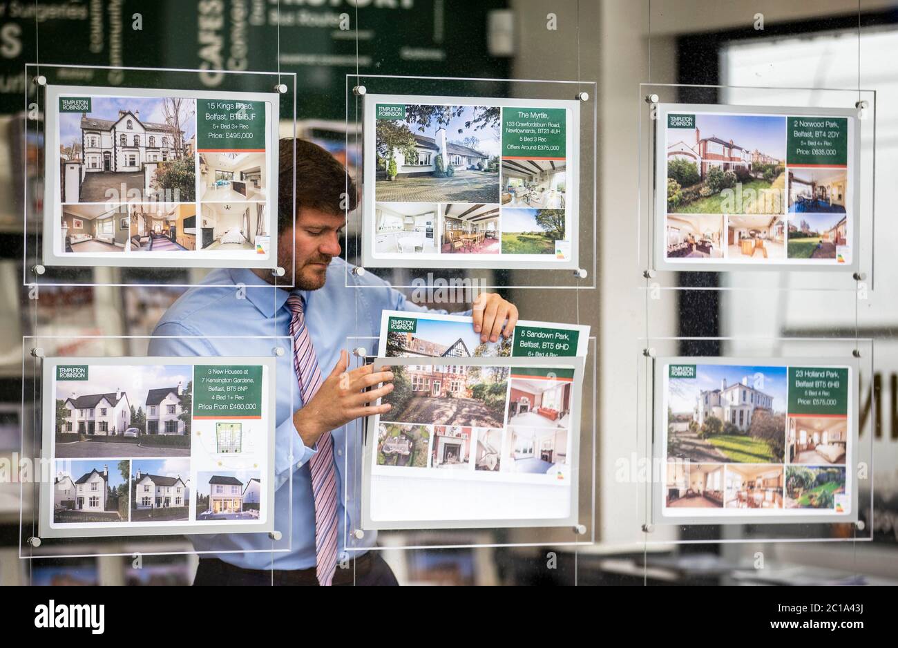 Templeton Robinson estate agent Brent Howell placing a for sale