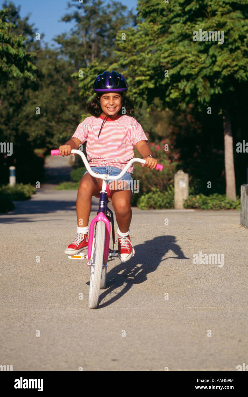 Girl 6 7 year old riding bicycle ethnic diversity racially