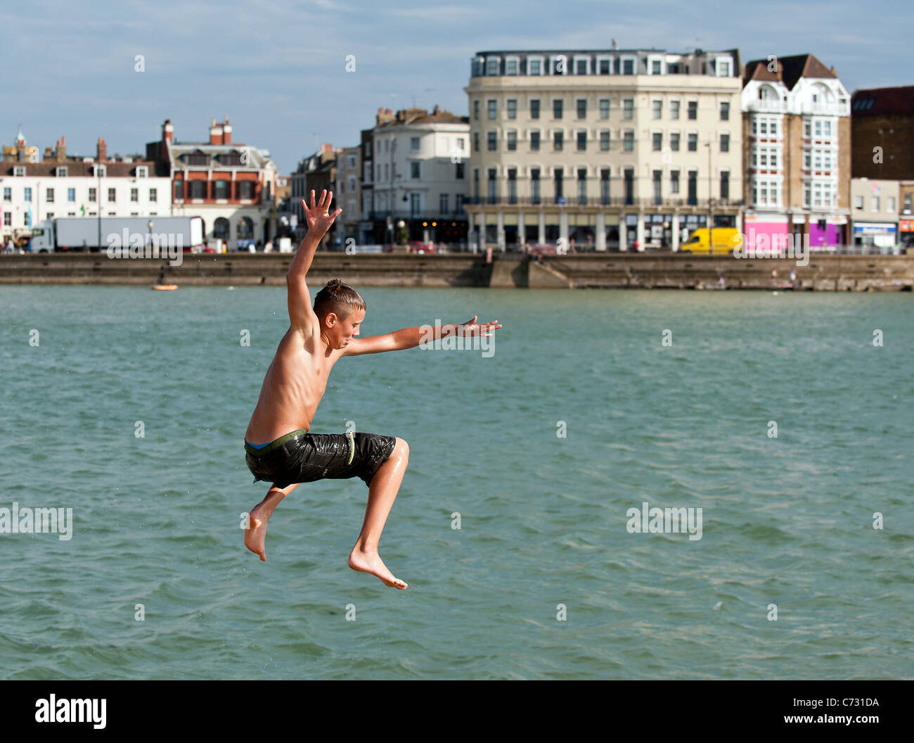 A boy tombstoning off the harbour at Margate in Kent Stock Photo - Alamy