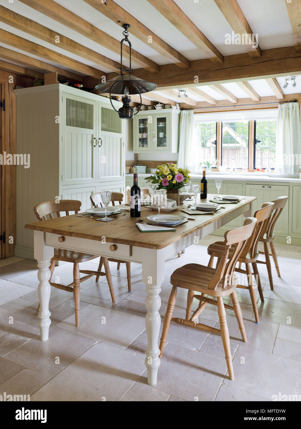 Table laid for dinner in country style dining room Stock Photo - Alamy